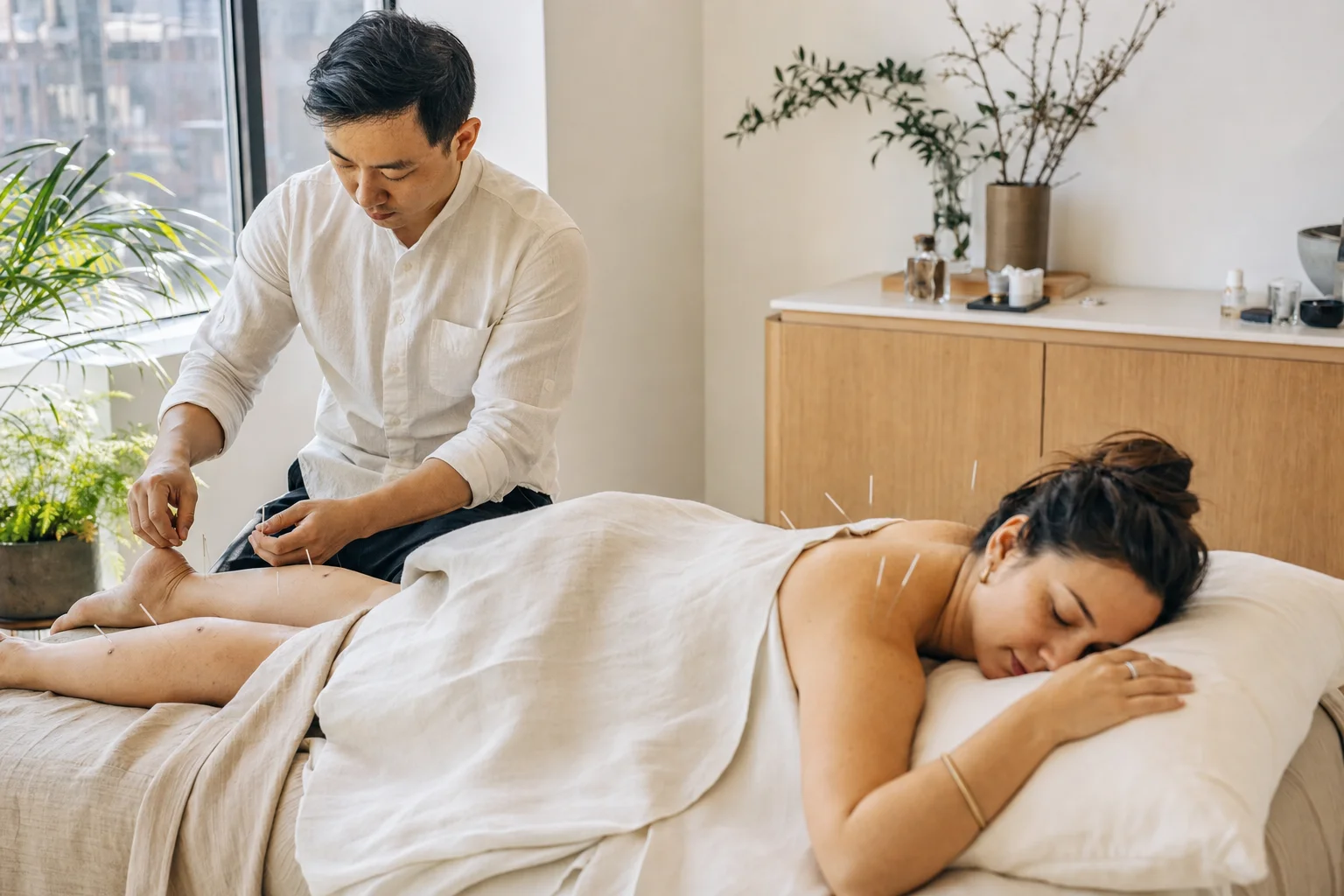 Practitioner treating multiple areas within one extended acupuncture visit